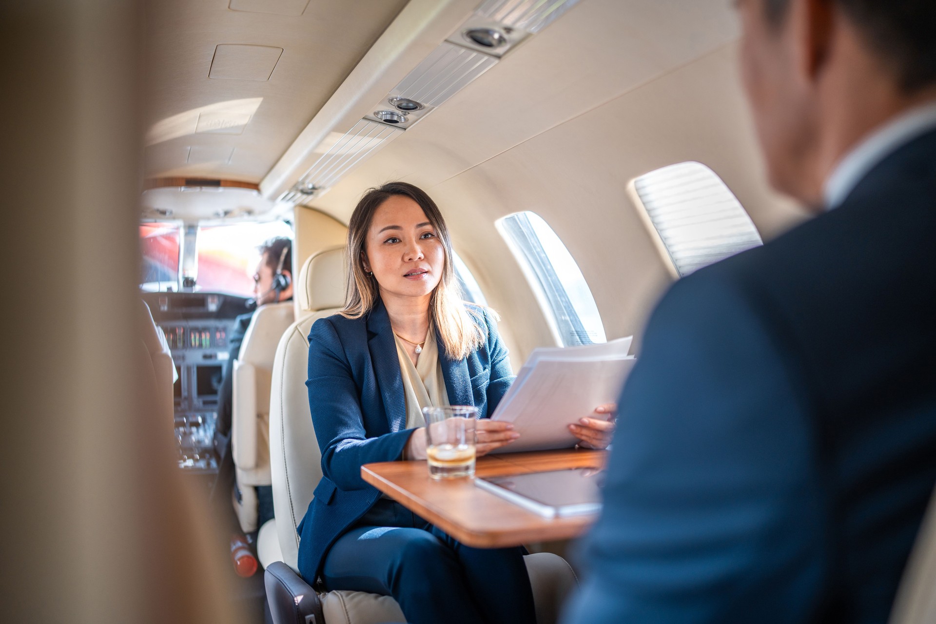 Mature Asian Business Executives Working in Private Jet