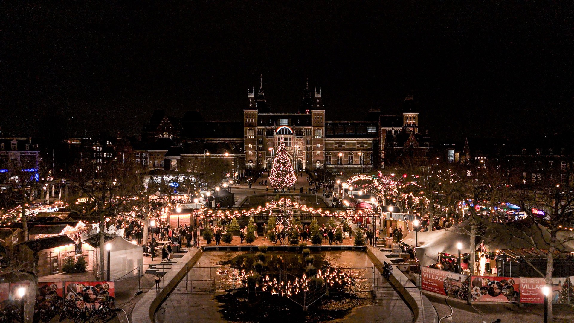 Aerial view of Christmas market in Amsterdam, people shopping at Christmas market, Christmas market with Christmas decorations and Christmas tree, Christmas Time in Europe, aerial view of Dutch Christmas market